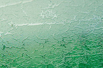 Abstract image. Green texture of the ice in the glass