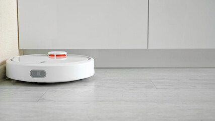 Close-up of a robot vacuum cleaner driving on the floor.