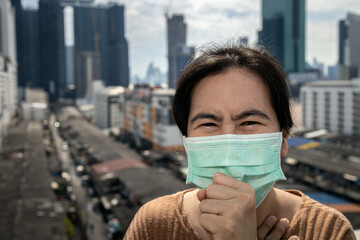 Sick asian woman had a cough,sore throat or symptoms of a cold flu,uncomfortable,people wearing medical protective mask in the city,concept of coronavirus COVID-19 infection,respiratory infections