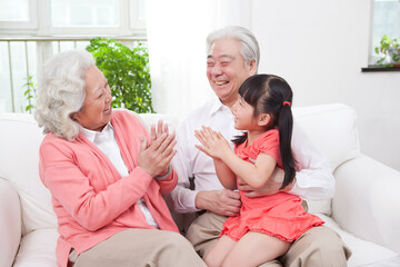 Happy grandparents and grandchildren are playing in the living room 