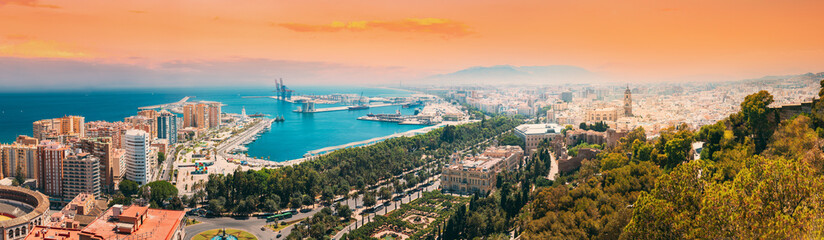 Malaga, Spain. Panorama Cityscape Elevated View Of Malaga In Sunny Summer Evening. Altered Sunset Sky