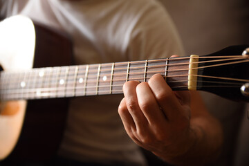 Fototapeta na wymiar Acoustic guitar fingerboard detail and hands playing