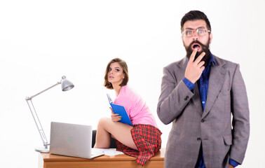 Obraz premium Office manager or secretary. Sexy lady office worker. Sexy personal secretary. Full of desire. Having crush at work boost sexual desire. Bearded boss stand in front of sexy girl working laptop