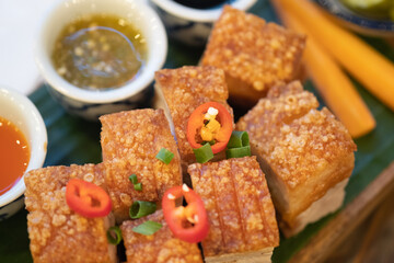 Deep fried pork belly served with dipping sauce