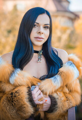 Woman in fox fur coat, choker on her neck . Concept of woman beauty and vintage fashion