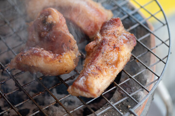 Neck pork on a charcoal stove.