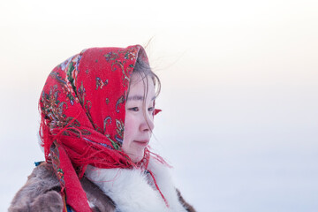 Young girl, in the national winter clothes of the northern inhabitants of the tundra, the Arctic...