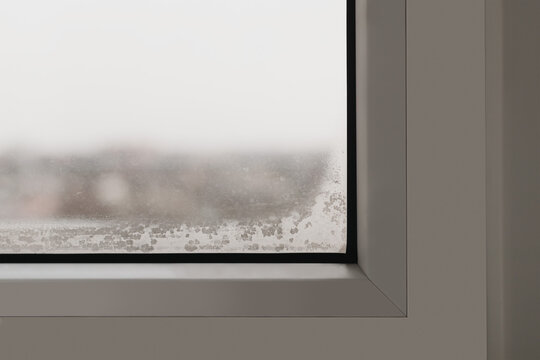 Fragment of a plastic window with a fogged double-glazed window