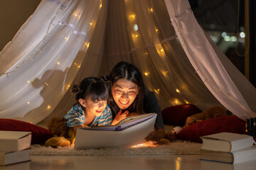Fototapeta na wymiar Happy family asian mother and daughter reading a book