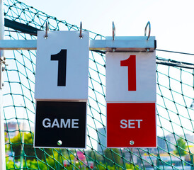 
Scoreboard on a tennis court during an outdoor game, close-up. Sports background. Game. Seth....