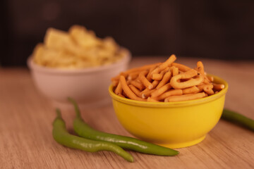 Gujarati local food Gadhiya with green pepper chili on wooden table,Chivda, Farsan, Namkin,