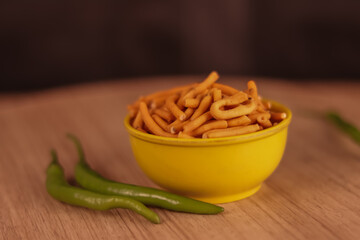 Gujarati local food Gadhiya with green pepper chili on wooden table,Chivda, Farsan, Namkin,