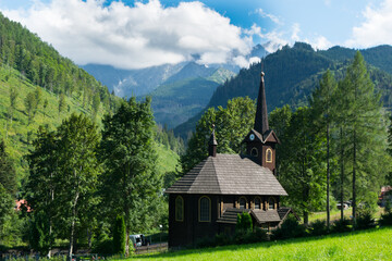Fototapeta na wymiar Wooden church on a meadow in mountains