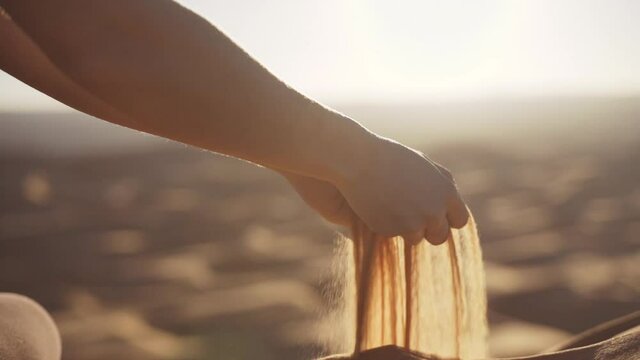 Woman'S Hands Pouring Desert Sand