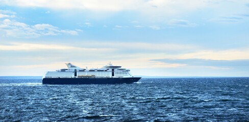 Passenger ferry on the Baltic sea. Dramatic cloudscape. Travel destinations, vacations, cruise, tourism, recreation