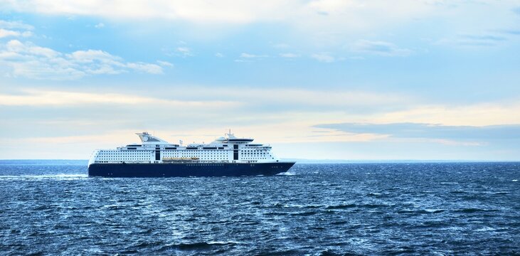 Passenger ferry on the Baltic sea. Dramatic cloudscape. Travel destinations, vacations, cruise, tourism, recreation