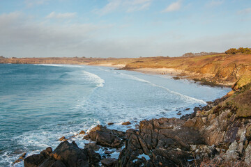 Waves are coming in the bay and crashing on the beach of Les Blancs Sablons, Finistère, Bretagne, France