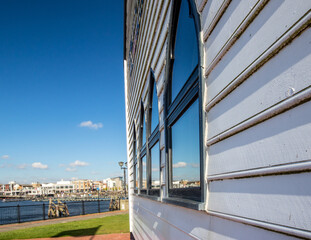 Reflections of the harbour in arched windows.