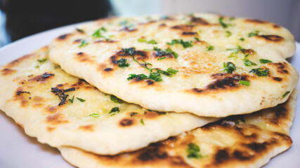 golden brown naan bread with parsley and garlic butter