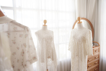 White wedding showroom with three dresses.