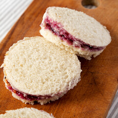 Homemade Crustless Peanut Butter  and Jelly Circles on a rustic wooden board, low angle view....