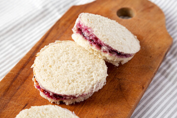 Homemade Crustless Peanut Butter  and Jelly Circles on a rustic wooden board, low angle view. Close-up.