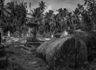 Ancient grave on old graveyard cemetery La Digue  Seychelles Indian ocean monochrome