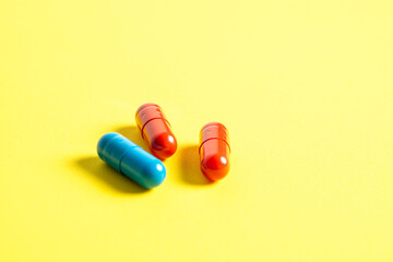 Heap of pills on yellow background