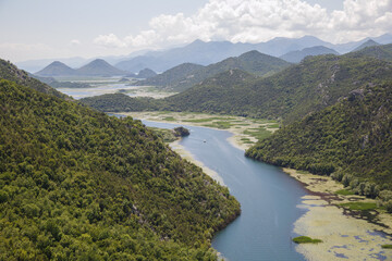 Fototapeta na wymiar Landscape with a river flowing among the mountains, Skadar Lake, Montenegro.
