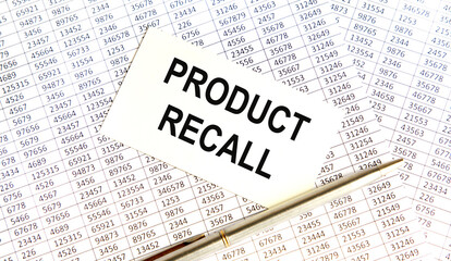 On the card text Product Recall, next to the pen, background are reports.