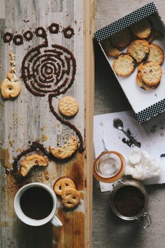 Making of an artistic photograph with sweet food, coffee, sugar, cookies