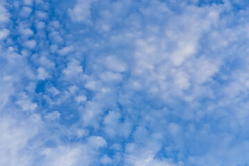 Blue clean sky with white clouds background