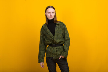 Androgen. Androgynous character on a yellow background. Man or woman. Military style.