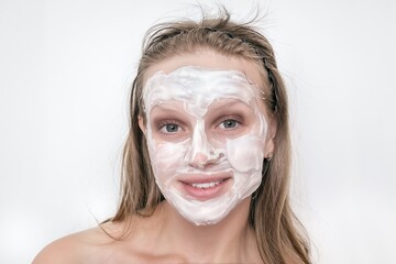 Woman with natural white cream mask on her face