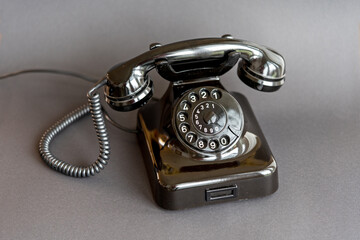 An old black telephone from the 50s with dial