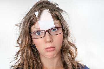 Funny woman with blank white sticky paper over her forehead