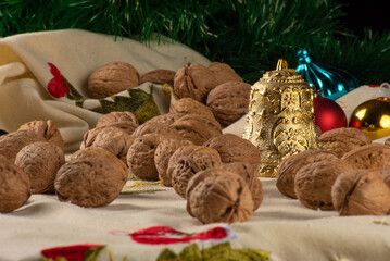 Christmas, Christmas ornaments and nuts on a table with cream towel, selective focus.