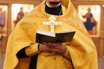 Orthodox Church. Christianity. Priest hands holding Holy Bible book in traditional Orthodox Church...