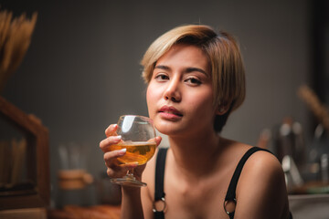 Attractive bartender girl holding in her hands fresh cocktail at the bar counter for celebration
