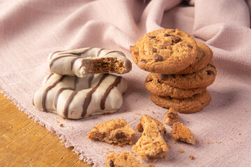 Cookies and pão de mel arranged on a rustic wooden surface with fabric, selective focus..