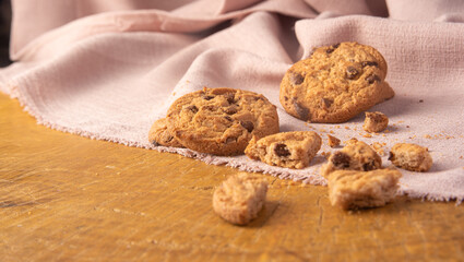 Cookies arranged on a rustic wooden surface with fabric, selective focus.