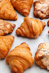 Fresh baked croissants on cement background.