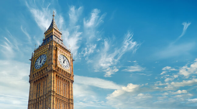Big Ben Clock Tower in London, UK, on a bright day. Panoramic composition withcopy-space, text space on blue sky with feather clouds.