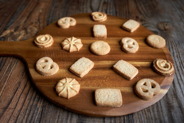 Fototapeta na wymiar Butter biscuits on wooden board