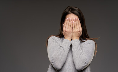 Woman covering her face