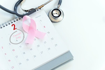 Cancer concept : Pink ribbon symbol of breast cancer and calendar background