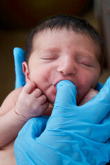 Young female doctor with newborn baby
