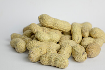 Handful of the raw peanuts on white background