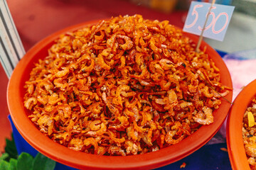 Small dried shrimp, food ingredients. Many tiny shrimps, prawns in a basket on a Vietnamese market