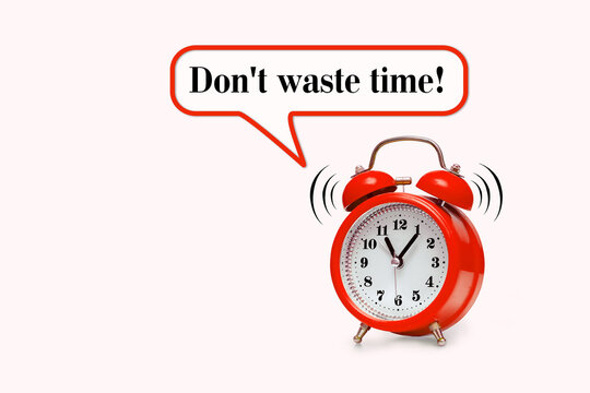 Red alarm clock and text - Don't waste time